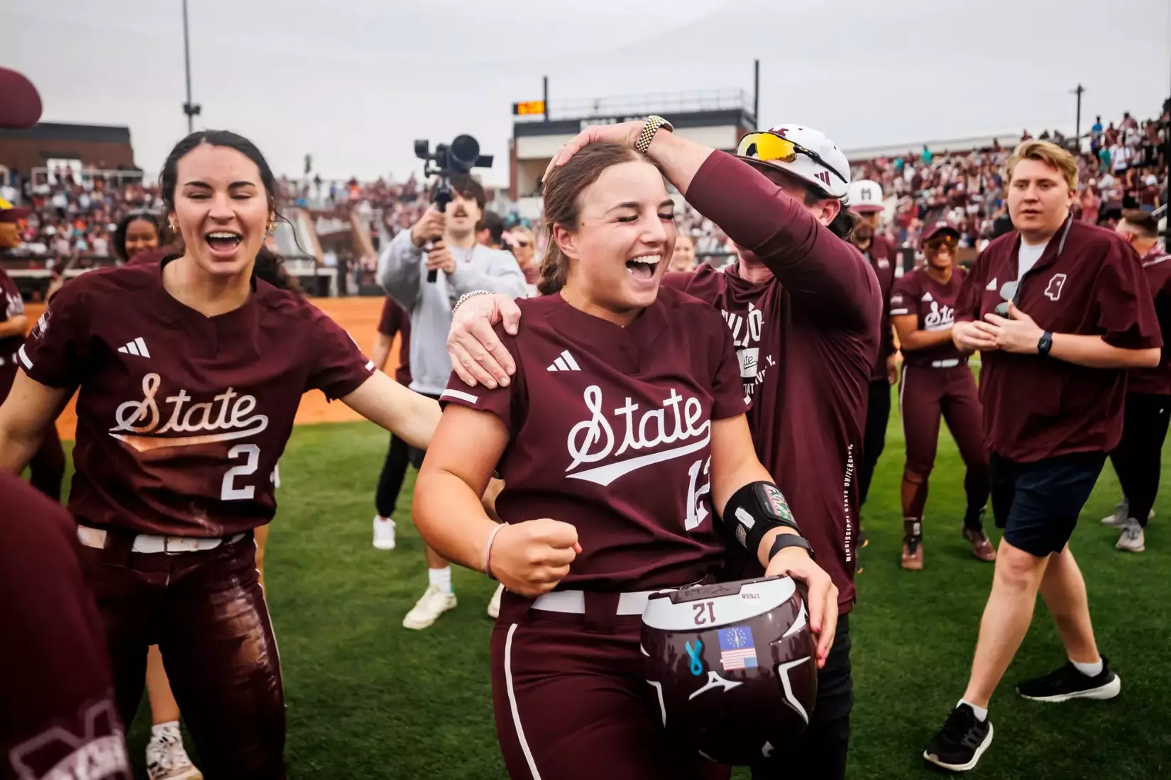 STARKVILLE, MS - March 28, 2025 - Mississippi State Catcher Paige Ernstes (#12) and Mississippi State Associate Head Coach Tyler Bratton during the game between the Texas Longhorns and the Mississippi State Bulldogs at Nusz Park in Starkville, MS. Photo By Hallie Walker