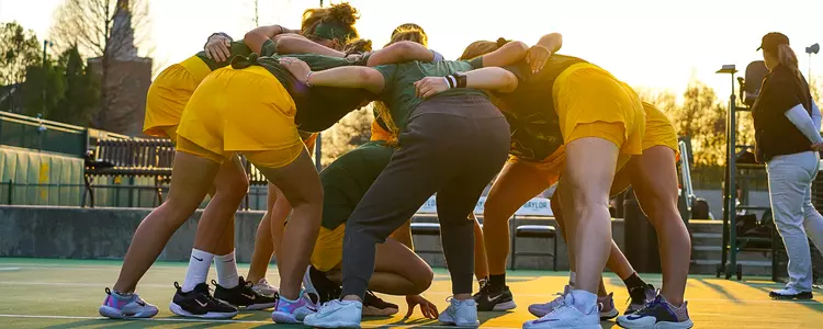 Women's Tennis team celebrate in 2023 vs. OSU