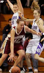 Kathrin Ress tries to drive around Holy Cross' Kaitlin Foley (52) and Brittany Keil during the first half.