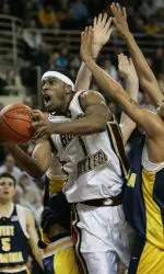 Boston College's Craig Smith drives through West Virginia defenders including Tyrone Sally for two of his game-high 23 points during second half action. (AP Photo/Elise Amendola)