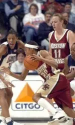 Aja Parham drives with the ball as Connecticut's Charde Houston, right, and Jessica Moore, left, defend during the first half.