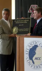 Gene DeFilippo (left) accepts an ACC plaque from John Swofford
