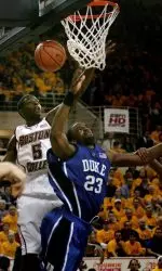 Duke forward Shelden Williams is stopped on a drive to the basket by Boston College forward Akida McLain.