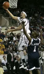 Boston College forward Sean Marshall , left, drives to the basket past Duquesne guard Aaron Jackson in the second half during a basketball game in Boston