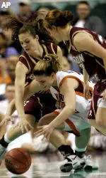 Virginia Tech's Laura Haskins, center, battles with Boston College's Ayla Brown, left, and Mickel Picco, right, in the second half. (APPhoto/Gerry Broome)