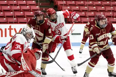 Kelly Browne and Cayla Barnes battle for position in front of the net against BU.