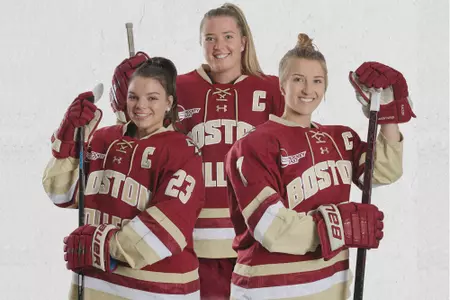 Cayla Barnes, Kelly Browne and Maegan Beres pose in their uniforms.