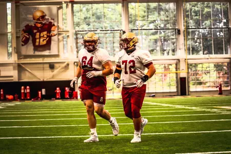 Ben Petrula and Alec Lindstrom jog off the field at Fish Field House - Preseason 2020