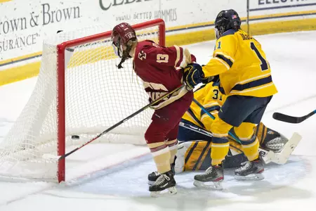 Jillian Fey watches the puck go in the net to score a goal against Merrimack.