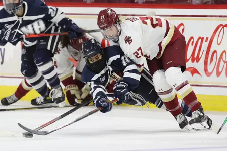 Willow Corson battles for the puck against UNH