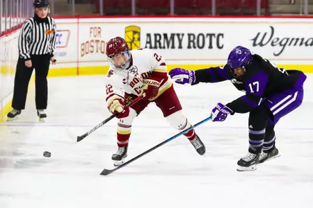 Olivia O'Brien shoots the puck into the zone.