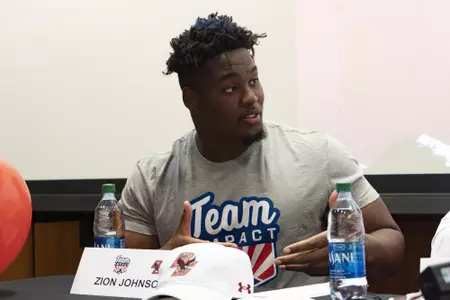 Zion Johnson talks at the team IMPACT signing.