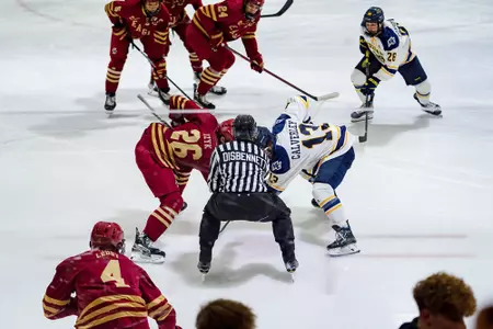 Liam Izyk takes a faceoff against Merrimack