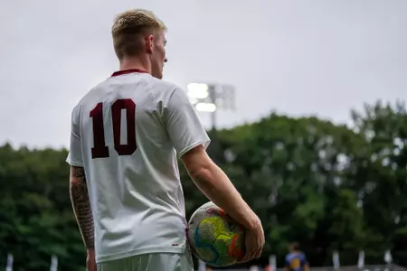 Alfie Hughes holds the ball before a throw in