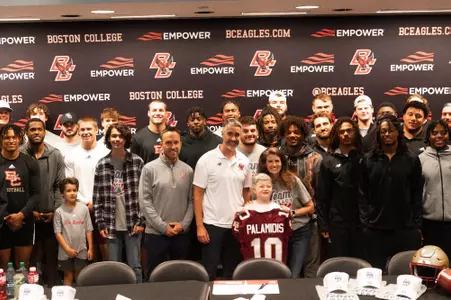 Nicholas and family pose with coach Hafley and the Eagles.