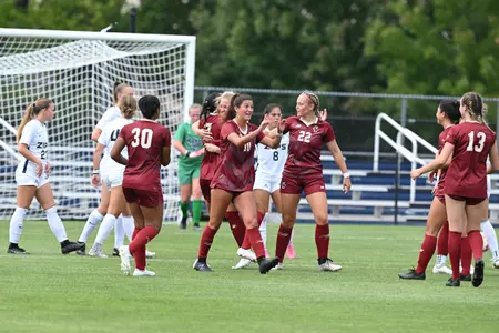 The team celebrating a goal at Akron 