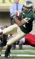 Damon Morton escapes a tackle by UNLV defensive back Jay Staggs during the first half. (AP Photo/Jack Dempsey)