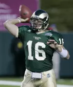 Caleb Hanie looks to throw during the first half. (AP Photo)