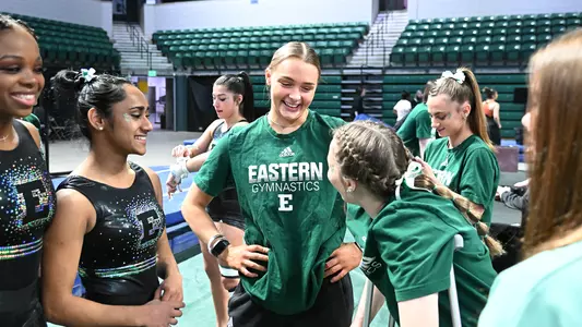 Katie Butler talking with teammates at Bowling Green meet 