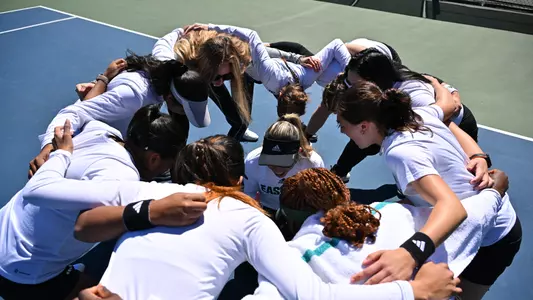 Tennis team huddle before match with Buffalo, 2024