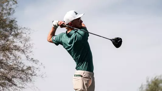 Joshua Hess holds his backswing while watching his drive go down the fairway