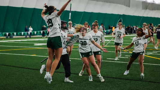 Lacrosse celebrates its come-from-behind victory over visiting Xavier, Feb. 14, as players jump in the air with smiles on their faces