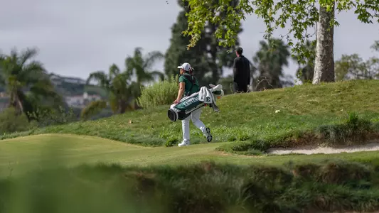 An Eastern Michigan women's golfer walks down the fairway at the GameAbove Invitational