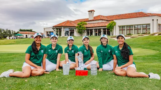 Janae Leovao, Mariana Vega, Erina Tan, Baiyok Sukterm, Savannah de Bock, and Jasmine Leovao sit on the fringe of the 18th green at Green Hills Country Club with the team and individual trophies won at the Silicon Valley Showcase, March 31, 2026