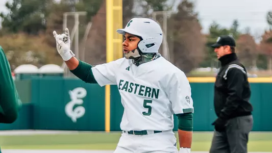 Phillip Thigpen celebrates to the dugout after getting on base against Michigan, April 6