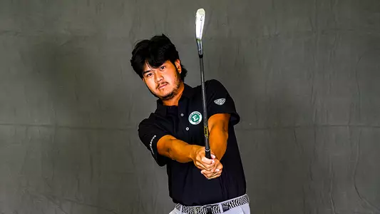 Arsit Areephun poses with his iron toward the camera during the EMU men's golf team's annual photoshoot