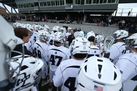 Men's Lacrosse team huddles on the sideline during a timeout