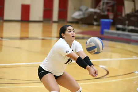 Michelle Cruz receives a ball during a volleyball match at Brown University