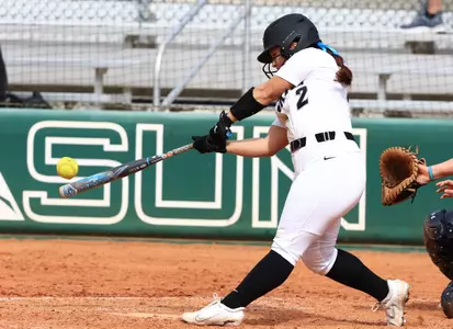 Tiana Wren swinging the bat in softball game