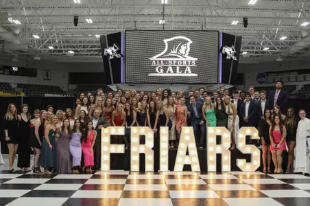 All-Sports Gala Senior Photo - 2023. Student-athletes from the senior class pose for a group photo on stage after the 62nd annual all-sports gala.