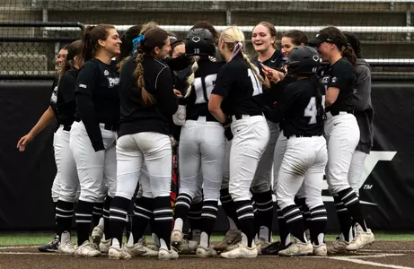 Softball Huddle celebrating home run 