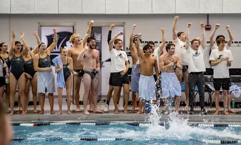 Swimming & Diving teams cheer on their teammates from the pool deck during a meet vs. Iona 