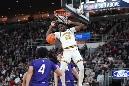 Oswin Erhunmwunse converts a dunk against Holy Cross at The Amica Mutual Pavilion. 