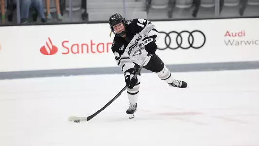 Women's ice hockey player Josie Lang making a pass during a game