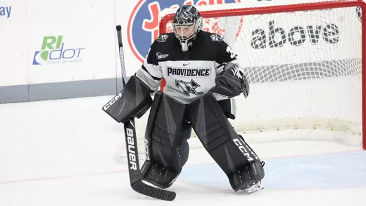 Women's ice hockey goaltender Mallory Hartl preparing to make a save
