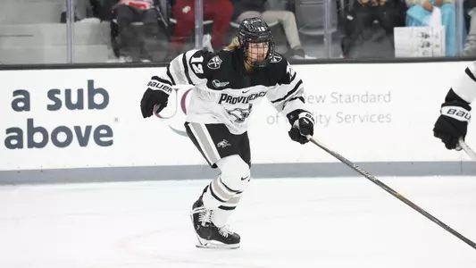 Women's ice hockey player Peyton Blaney skating up ice during a game