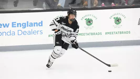 Women's ice hockey player Jessie Pellerin skating with the puck during a game