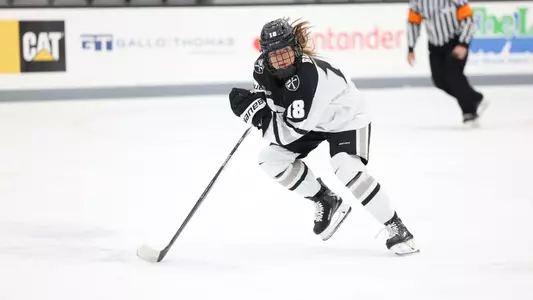 Women's ice hockey player Dylan Berman skating up ice during a game