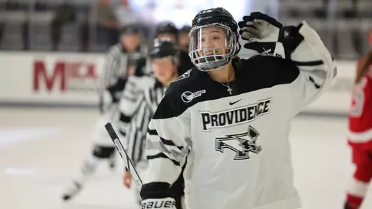 Women's ice hockey player Kayla Kutes celebrating a goal