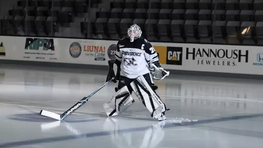 Women's ice hockey player Hope Walinski skating to the blue line for player introductions