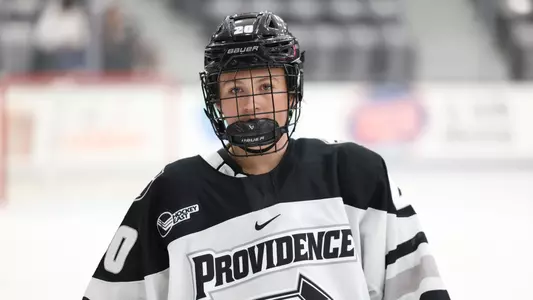 Women's ice hockey player Molly Farace skating to the bench during a media timeout