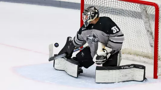 Men's Hockey's Philip Svedeback makes a save against UConn