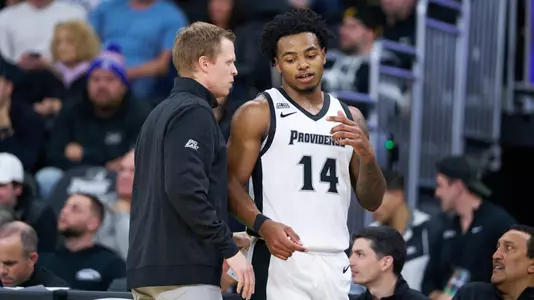 Corey Floyd Jr talks to Brian Tibaldi on the sideline at the Amica Mutual Pavilion versus FDU. 