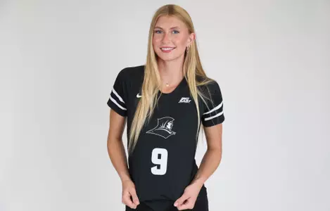 Tori Otter is pictured showing her jersey off and smiling at the camera during team photoshoot for pre-season 2025 photos.