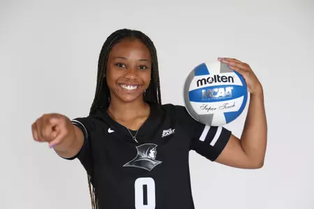Hadley Pride is pictured holding the ball in her left arm while she points at the camera with her right during team photoshoot for pre-season 2025 photos.