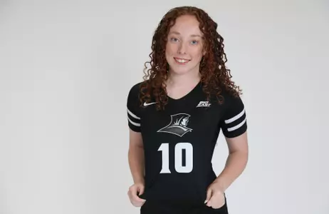 Morgan Martin is pictured showing off her jersey and smiling at the camera during team photoshoot for pre-season 2025 photos.